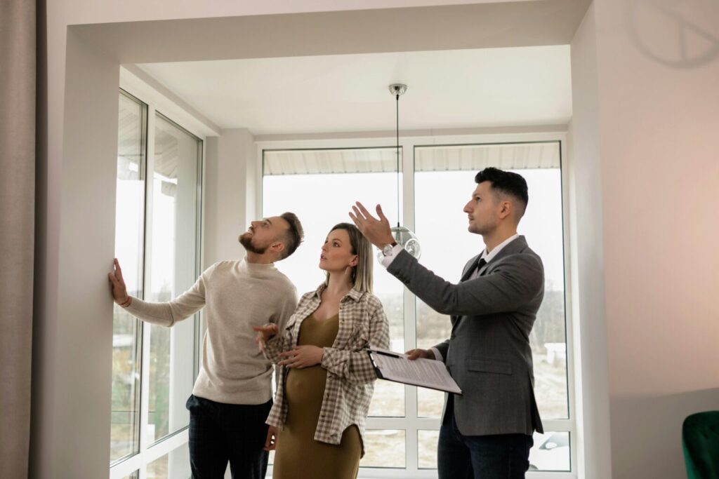 A property specialist showing a couple a home